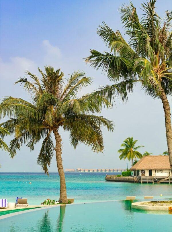 Maldives tour package showcasing luxury beach views, turquoise waters, and resort experiences