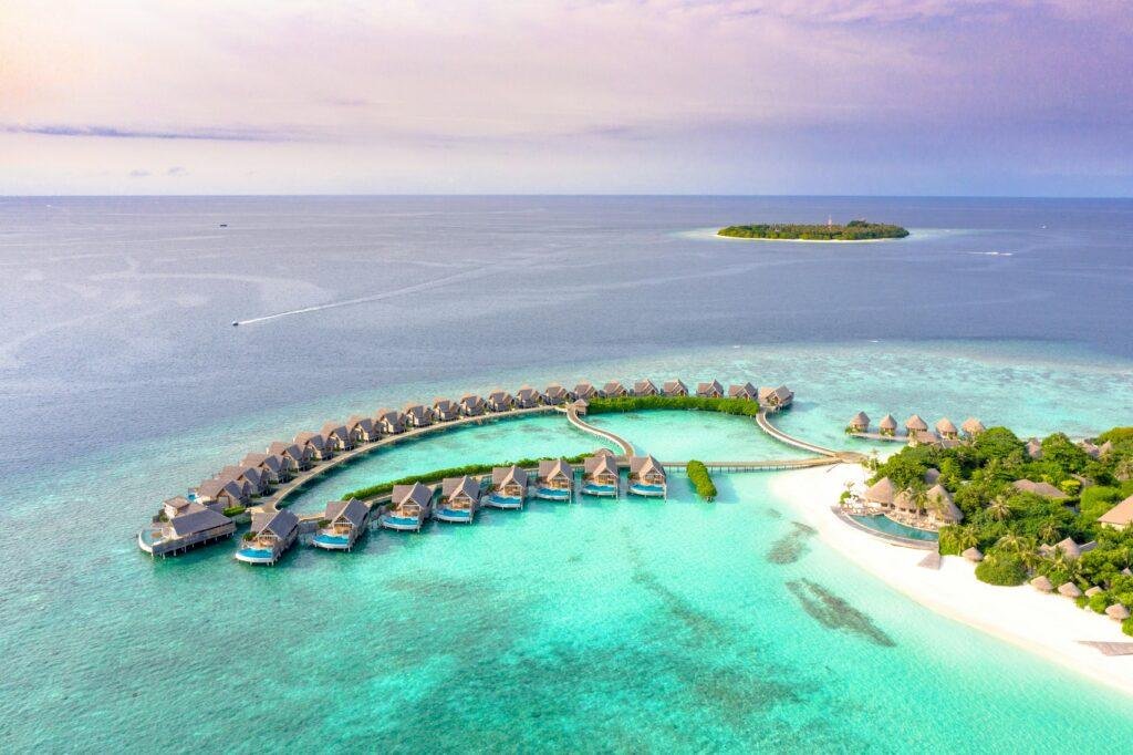 Sun Siyam Maldives luxury resort beachfront and overwater villas with turquoise lagoon